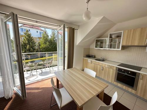 a kitchen with a table and chairs and a balcony at Ośrodek Wczasowy Walcownik in Sianozety