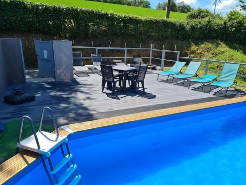 a patio with a table and chairs next to a pool at Millstone Gite 1, two bed apartment + shared pool in Chassenon