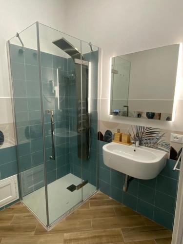 a bathroom with a glass shower and a sink at Casa Gina e Pietro in Ustica