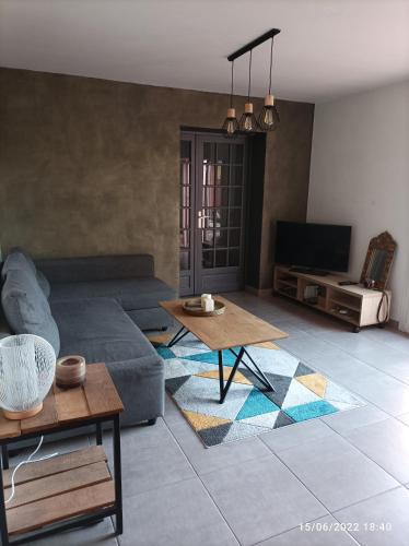 a living room with a couch and a table at Maison de vacances, proche de la plage in Fréjus