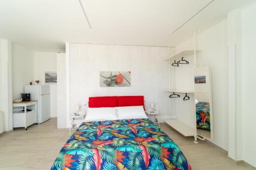 a bedroom with a bed with a colorful bedspread at Nni Mia in Modica