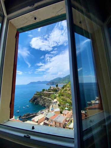 a view of the ocean from a window at Le Storie di Manarola in Manarola
