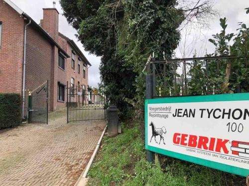 a sign in front of a building with a dog on it at Charming authentic renovated farm in Cadier en Keer