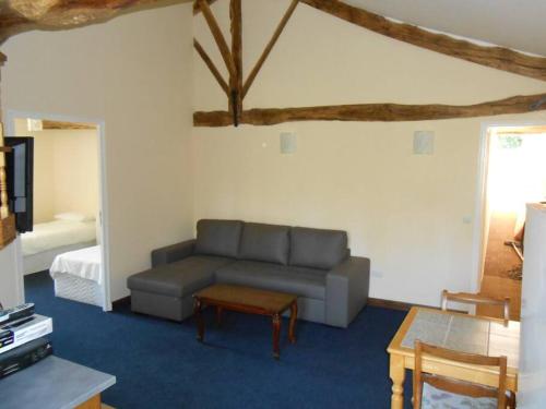 a living room with a couch and a table at Millstone Gite 2, two bed apartment + shared pool in Chassenon