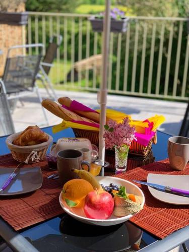 a table with a plate of food and fruit on it at Millstone Gite 2, two bed apartment + shared pool in Chassenon