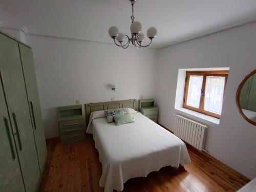 a bedroom with a white bed and a window at VUT Corea324 in Caboalles de Abajo