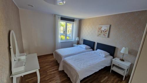 a hotel room with two beds and a window at Kivi Residence in Pärnu