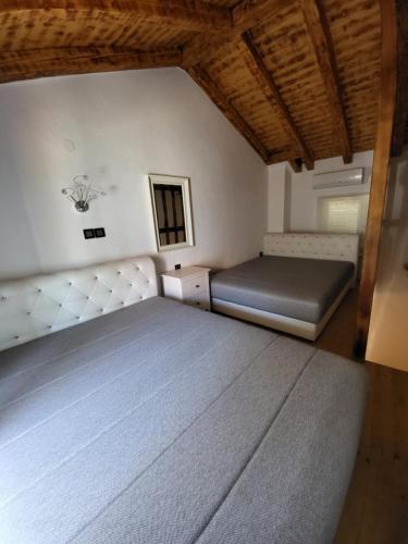 a bedroom with a bed and a mirror at Mini Villa Punta in Zadar