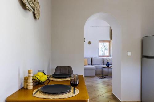a kitchen with a table with two plates on it at Villa Koukounaria in Skopelos Town
