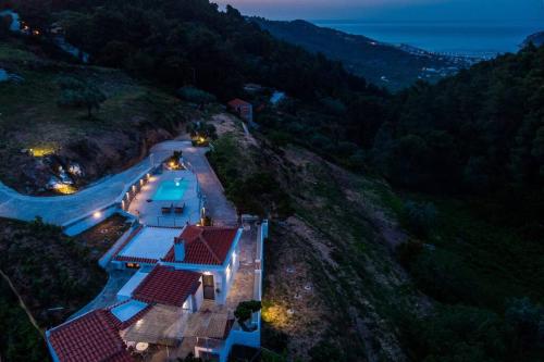 an aerial view of a house on a hill at Villa Koukounaria in Skopelos Town