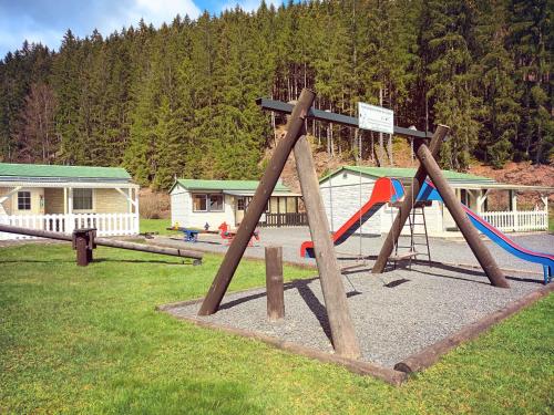 a park with a playground with a swing at Ebermannsmühle in Lauscha