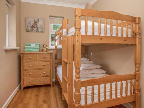 a bedroom with a bunk bed and a dresser at Gatekeepers Cottage - Uk6728 in Lydstep