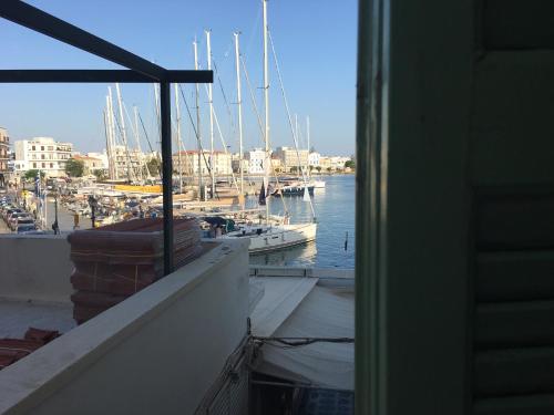 a view from a window of a marina with boats at Aegli 1876 in Tinos Town