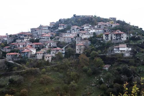 a group of houses on top of a hill at Bezeniko Amazing Arcadian Property! in Vlakhérna