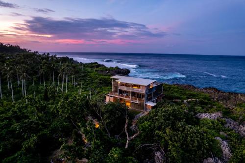 a house on a cliff next to the ocean at Izustarri in Burgos