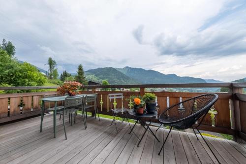 a wooden deck with a table and chairs on it at Appartements Chalet Le Fornay in Morzine