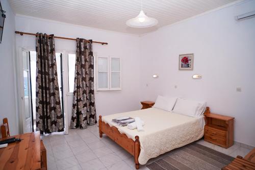 a bedroom with a bed in a room at Kostas Beach Apartments in Agios Gordios