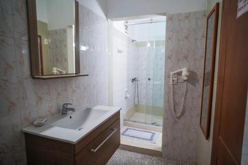a bathroom with a sink and a shower at Kostas Beach Apartments in Agios Gordios