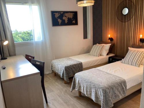 Ένα ή περισσότερα κρεβάτια σε δωμάτιο στο Appart'Hotel - Gare TGV - Courtine - Confluence - 407