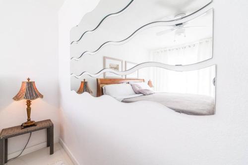 a bedroom with a bed and a mirror on the wall at 2 BEDROOM ON THE BEACH ! in Miami Beach