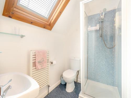 a bathroom with a toilet and a sink and a shower at Mays - Uk43788 in Sewerby