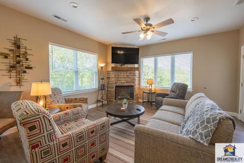 a living room with a couch and chairs and a fireplace at NEW BUILD - Walk-In - Resort Amenities - Near 76 Strip - FREE TICKETS INCLUDED - FH-G201 in Branson