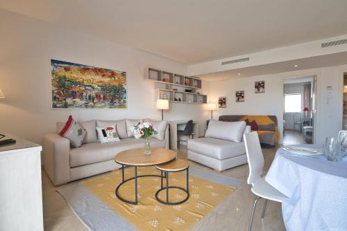 a living room with a couch and a table at Luxury Apartment 90sqm with Pool near Beach WIFI Unlimited Optical Fiber in Agadir