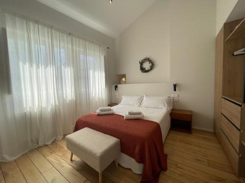 a bedroom with a large bed with a red blanket at housingcoruña SAN NICOLAS 27 in A Coruña
