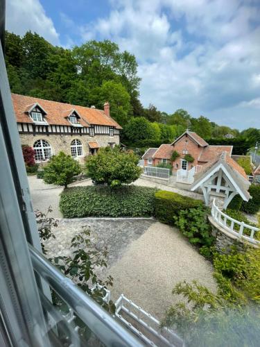 a view of a house from a window at Domaine de l’Orangerie - La Suite Eucalyptus in Boissise-la-Bertrand