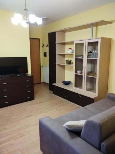 a living room with a couch and a entertainment center at Parco Madonnetta in Acilia
