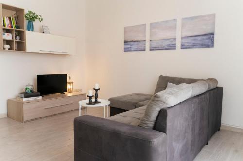 a living room with a couch and a tv at Cielo Mare in Viareggio