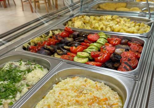 a buffet filled with different types of vegetables in trays at Hotel Majestic Olimp All Inclusive in Olimp