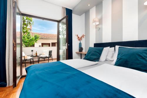 a bedroom with a large bed and a large window at Villa B&B Marina & Parking Free in Rovinj