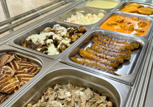 a display case filled with different types of food at Hotel Majestic Olimp All Inclusive in Olimp