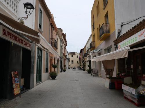 an empty street in a town with buildings at Hostal de la Plaça - Hotel Boutique in Cabrils