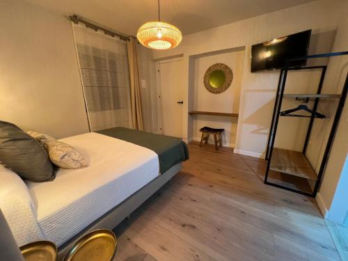 a bedroom with a bed and a television in it at Casal de pelaio in Barreiros