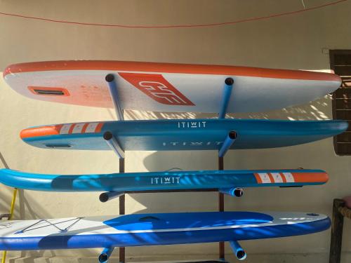 a group of three surfboards sitting on a rack at Summer Beach Paje in Paje
