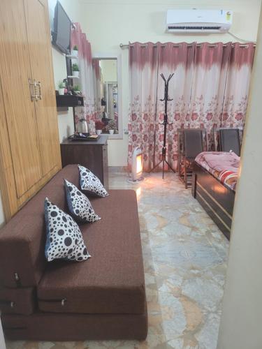 a living room with a couch and a bed at Dhairya's Villa Home Away From Home in Jammu