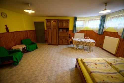 バラトンフレドにあるHuszár Vendégházのベッド2台、テーブル、椅子が備わる客室です。