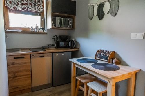 a small kitchen with a table and a counter top at Ostoja Gorce in Nowy Targ