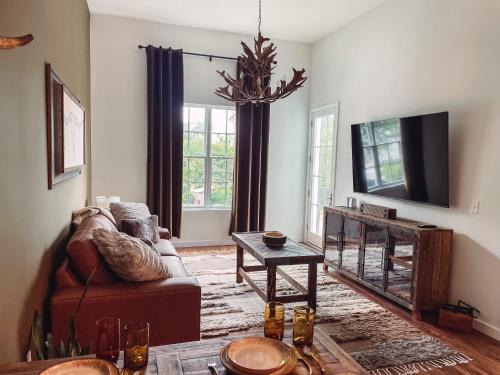 a living room with a couch and a tv at Rustic Chic - Boutique Luxe Stay Near Broadway in Nashville