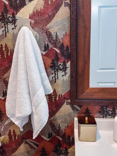 a bathroom with a towel hanging on a wall at Cozy Cabin - 2 Miles to Broadway & Free Parking in Nashville