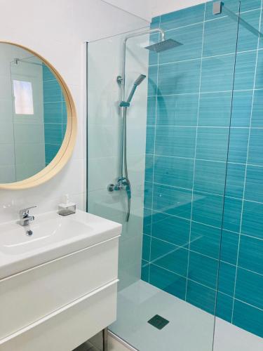 a bathroom with a glass shower and a sink at Apartamento Aqua Clara in Puerto del Carmen