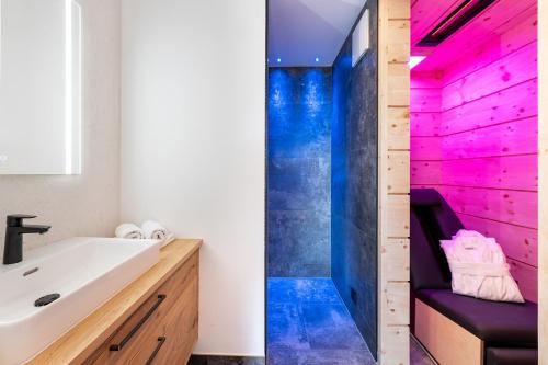 a bathroom with a sink and a shower at Hotel AlpenSchlössl in Söll