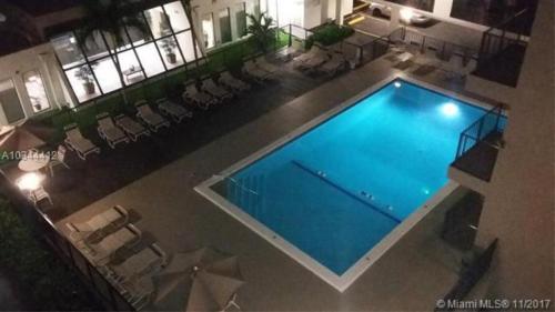 an overhead view of a swimming pool in a building at Amazing condo 5 minute walk to the beach! in Miami Beach