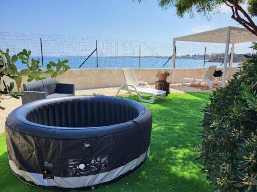 a backyard with a fire pit in the grass at La Caletta di Afrodite in Calabernardo