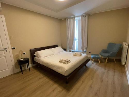 a bedroom with a bed and a blue chair at B&B Ai Cortili in Sant'Egidio del Monte Albino