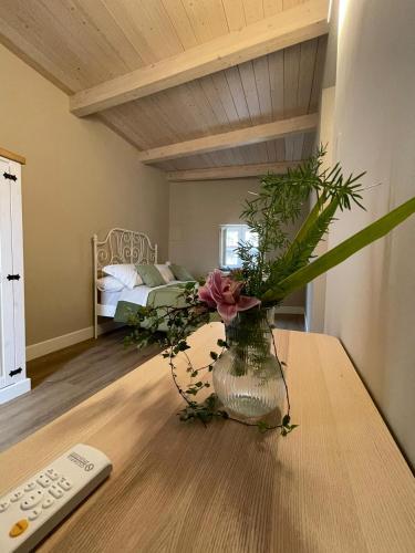 a vase with flowers on a table in a room at B&B Ai Cortili in Sant'Egidio del Monte Albino