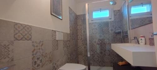 a bathroom with a shower and a toilet and a sink at La Quagnola Casa vacanze in Polinago