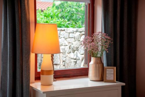 a lamp sitting on a table next to a window at Villa B&B Marina & Parking Free in Rovinj
